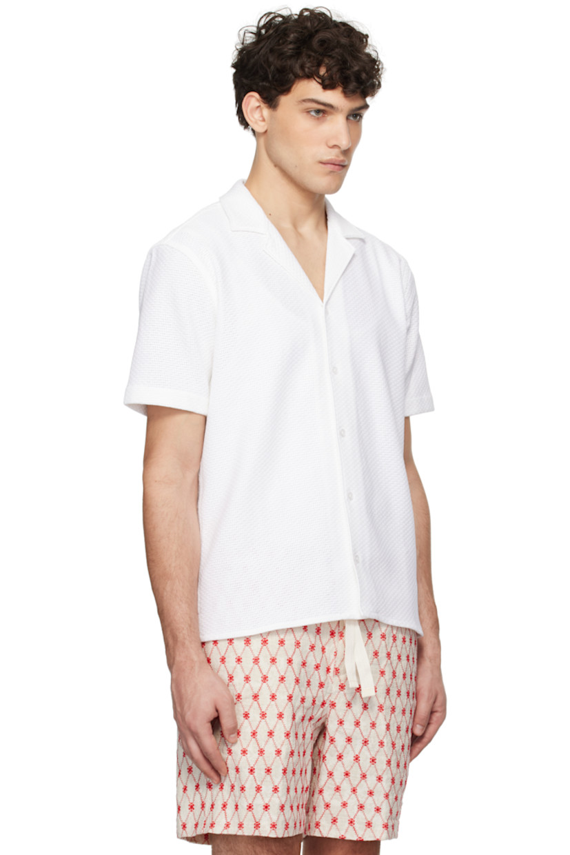 Leno-woven cotton shirt.

· Open spread collar
· Button closure
· Tennis-tail hem
· Pleats at back yoke

Supplier color: Cloud