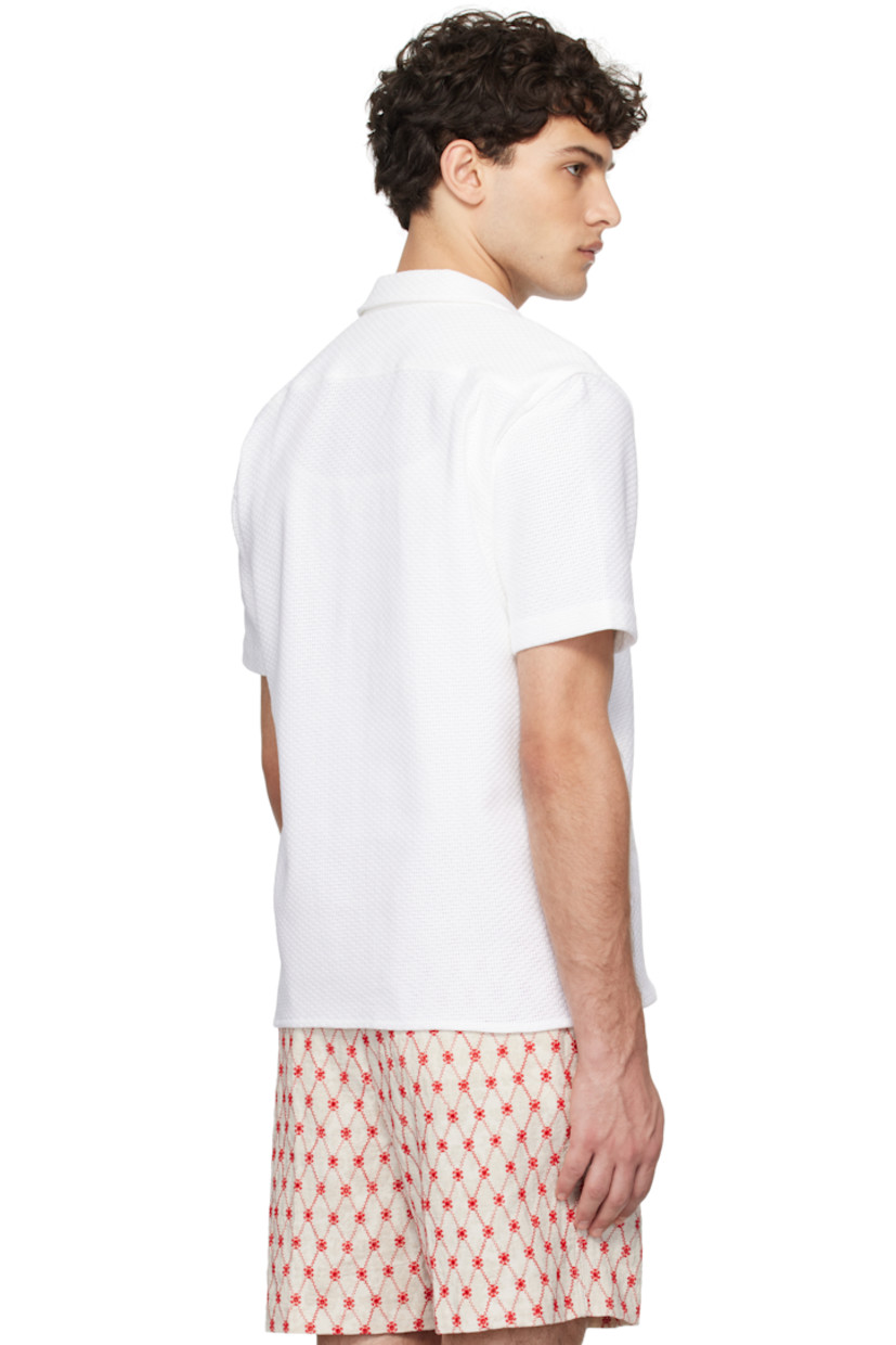 Leno-woven cotton shirt.

· Open spread collar
· Button closure
· Tennis-tail hem
· Pleats at back yoke

Supplier color: Cloud