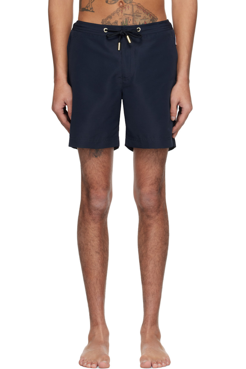 Lightweight polyester faille swim shorts.

· Drawstring at elasticized waistband
· Three-pocket styling
· Zip fly
· Vented cuffs
· Logo flag at outseam
· Locker loop at back waistband
· Briefs-style mesh lining

Supplier color: Night iris