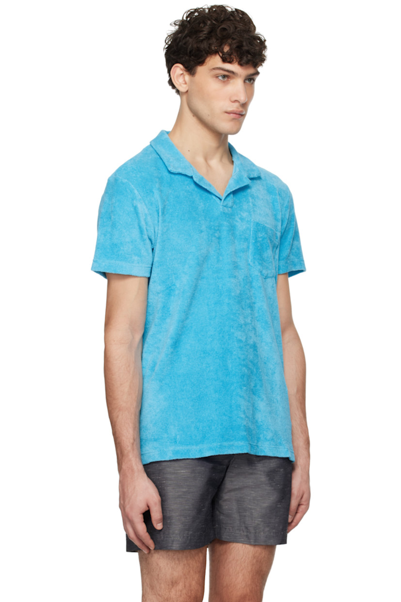 Organic cotton terrycloth polo.

· Spread collar
· Open placket
· Patch pocket at chest
· Tennis-tail hem
· Logo flag at side seam

Supplier color: Aqua blue