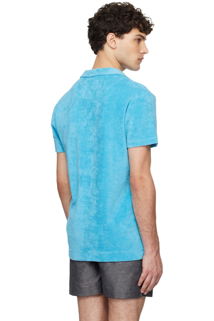 Organic cotton terrycloth polo.

· Spread collar
· Open placket
· Patch pocket at chest
· Tennis-tail hem
· Logo flag at side seam

Supplier color: Aqua blue