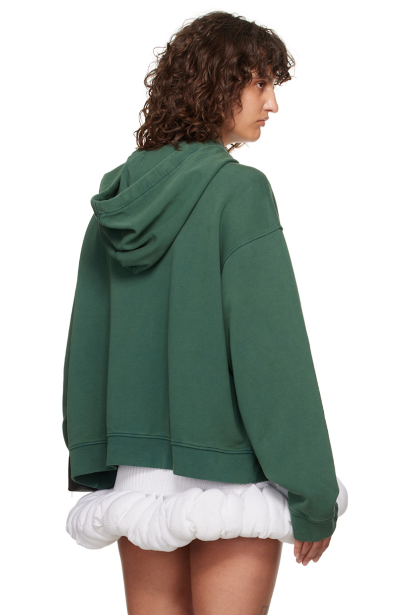French terry hoodie. 

· Drawstring at hood
· Text printed at front
· Kangaroo pocket
· Rib-knit hem and cuffs
· Dropped shoulders

Supplier color: Bottle green