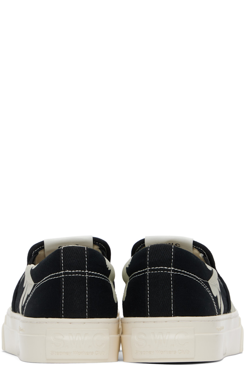 Low-top canvas slip-on sneakers in black and white.

· Graphics printed throughout
· Logo patch at tongue
· Elasticized gussets
· Padded collar
· Mesh lining
· Logo embossed at midsole 
· Treaded rubber sole
· Contrast stitching in white

Supplier color: Black/White