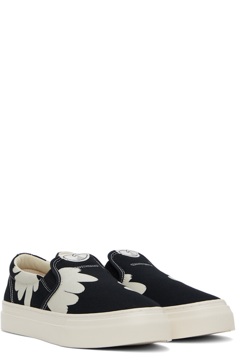 Low-top canvas slip-on sneakers in black and white.

· Graphics printed throughout
· Logo patch at tongue
· Elasticized gussets
· Padded collar
· Mesh lining
· Logo embossed at midsole 
· Treaded rubber sole
· Contrast stitching in white

Supplier color: Black/White