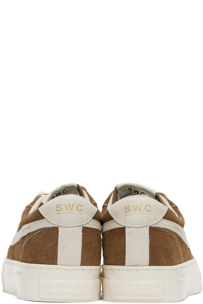 Low-top suede and buffed leather sneakers in brown and white.

· Lace-up closure
· Logo patch at padded tongue
· Padded collar
· Text printed at outer side
· Logo printed at heel tab
· Mesh lining
· Logo embossed at midsole
· Treaded rubber sole
· Contrast stitching in white

Supplier color: Brown
