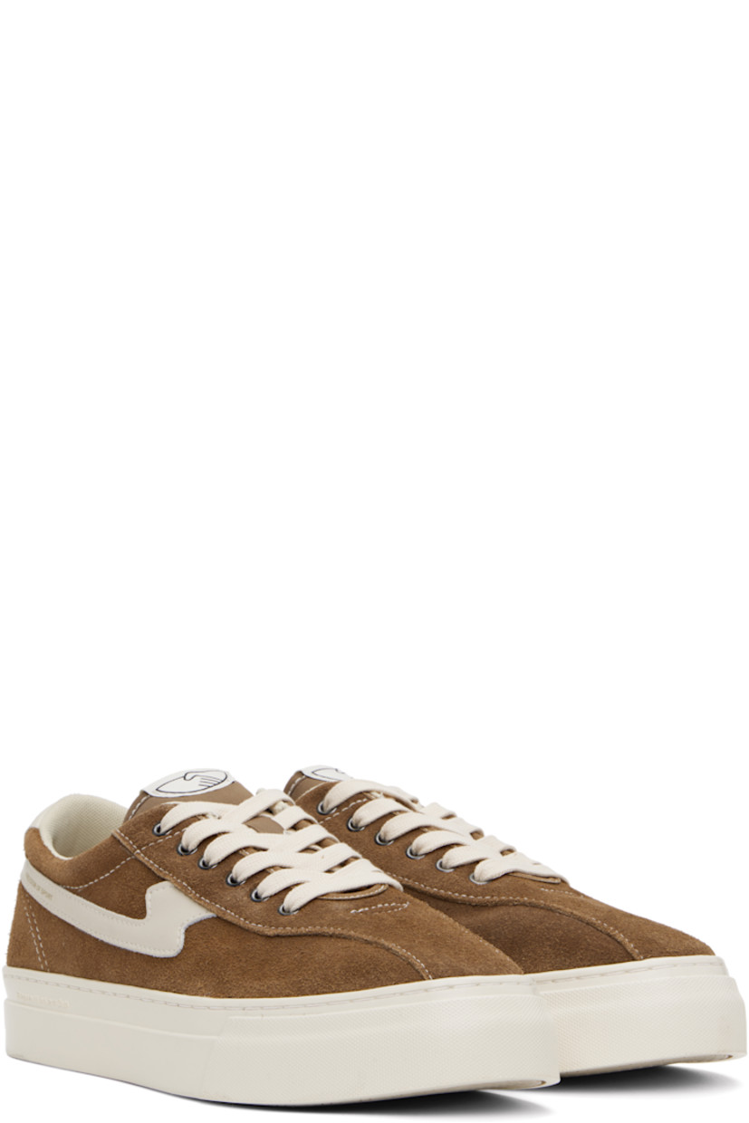 Low-top suede and buffed leather sneakers in brown and white.

· Lace-up closure
· Logo patch at padded tongue
· Padded collar
· Text printed at outer side
· Logo printed at heel tab
· Mesh lining
· Logo embossed at midsole
· Treaded rubber sole
· Contrast stitching in white

Supplier color: Brown