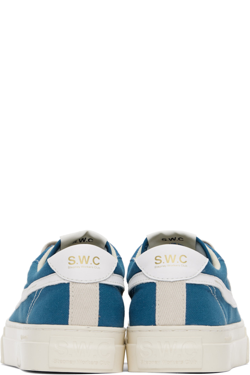 Low-top canvas and buffed leather sneakers in blue and white.

· Lace-up closure
· Logo patch at padded tongue
· Padded collar
· Text printed at outer side
· Logo printed at heel tab
· Mesh lining
· Logo embossed at midsole
· Treaded rubber sole
· Contrast stitching in white

Supplier color: Sea blue