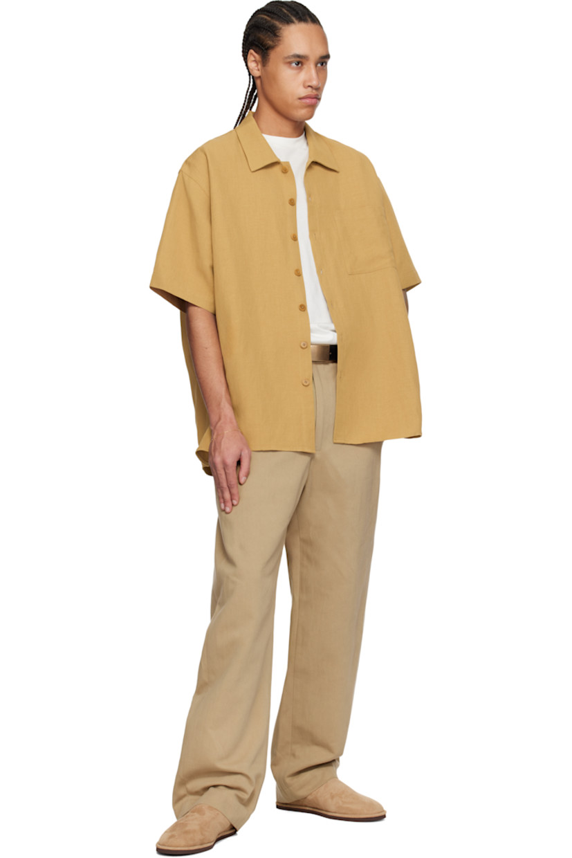 Oversized viscose- and linen-blend twill shirt. 

· Spread collar
· Button closure
· Patch pocket
· Curved hem
· Dropped shoulders
· Twin pleats at back yoke
· Corozo hardware

Supplier color: Burnt orange