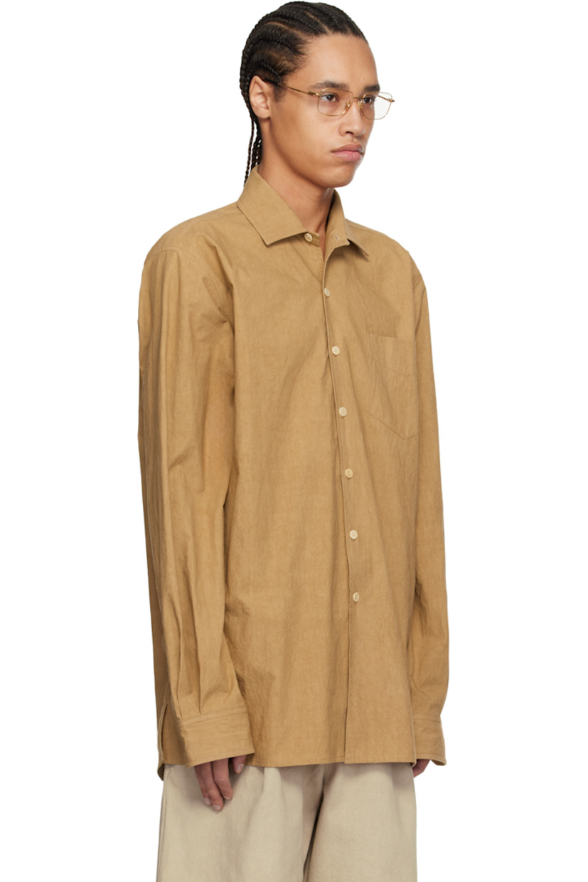 Crinkled cotton poplin shirt. 

· Spread collar
· Button closure
· Patch pocket
· Vented side seams
· Dropped shoulders
· Single-button barrel cuffs
· Corozo hardware

Supplier color: Burnt orange
