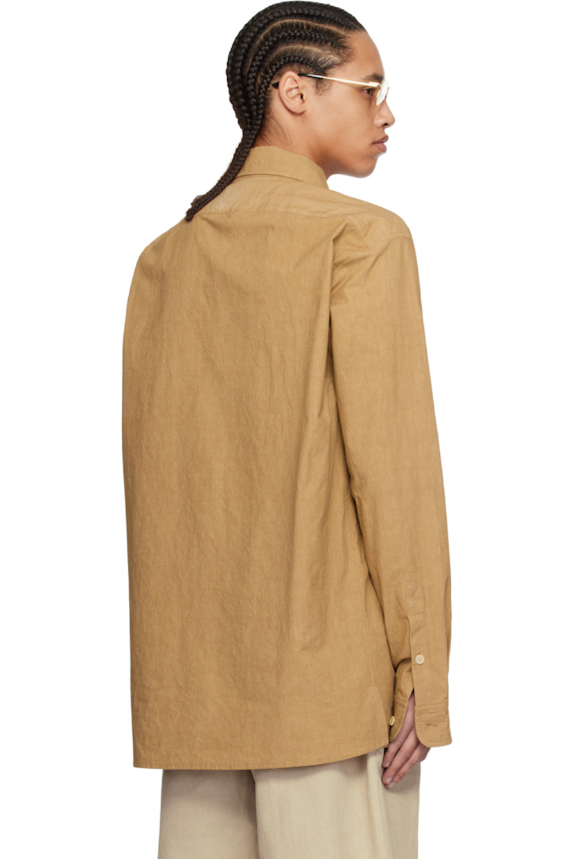 Crinkled cotton poplin shirt. 

· Spread collar
· Button closure
· Patch pocket
· Vented side seams
· Dropped shoulders
· Single-button barrel cuffs
· Corozo hardware

Supplier color: Burnt orange