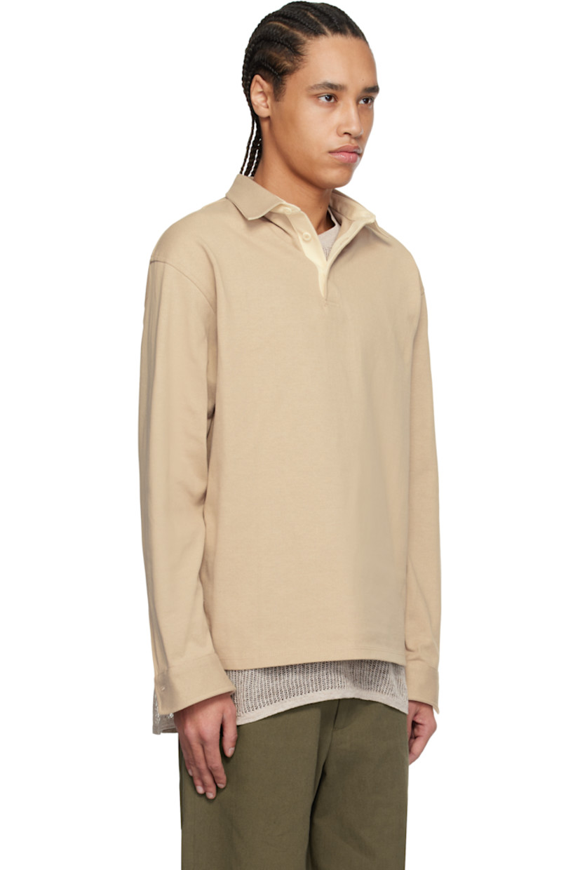 Cotton jersey polo. 

· Spread collar
· Three-button placket
· Dropped shoulders
· Adjustable single-button cuffs
· Twill panel at inner collar and cuffs
· Corozo hardware

Supplier color: Greige