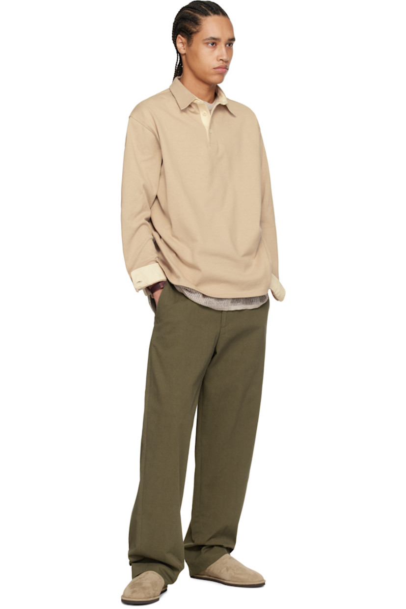 Cotton jersey polo. 

· Spread collar
· Three-button placket
· Dropped shoulders
· Adjustable single-button cuffs
· Twill panel at inner collar and cuffs
· Corozo hardware

Supplier color: Greige