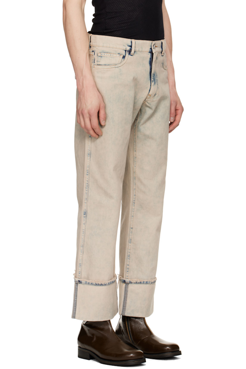 Loose-fit non-stretch denim jeans. Fading and distressing throughout.

· Mid-rise
· Belt loops
· Five-pocket styling
· Zip fly
· Rolled cuffs
· Strap with logo hardware at back pocket
· Contrast stitching in tan

Supplier color: Grey/Greige