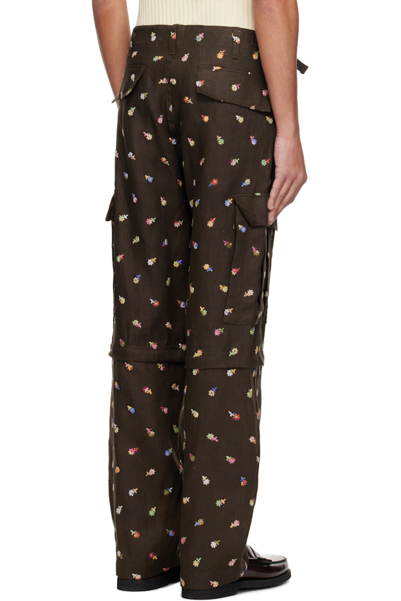 Linen twill cargo pants. Floral pattern embroidered throughout.

· Belt loops
· Four-pocket styling
· Zip fly
· Cinch straps at waistband
· Zip fastening at knees for shorts styling
· Drawstring at cuffs
· Cargo pocket at outseams
· Logo embroidered at back
· Buffalo horn hardware

Supplier color: Brown