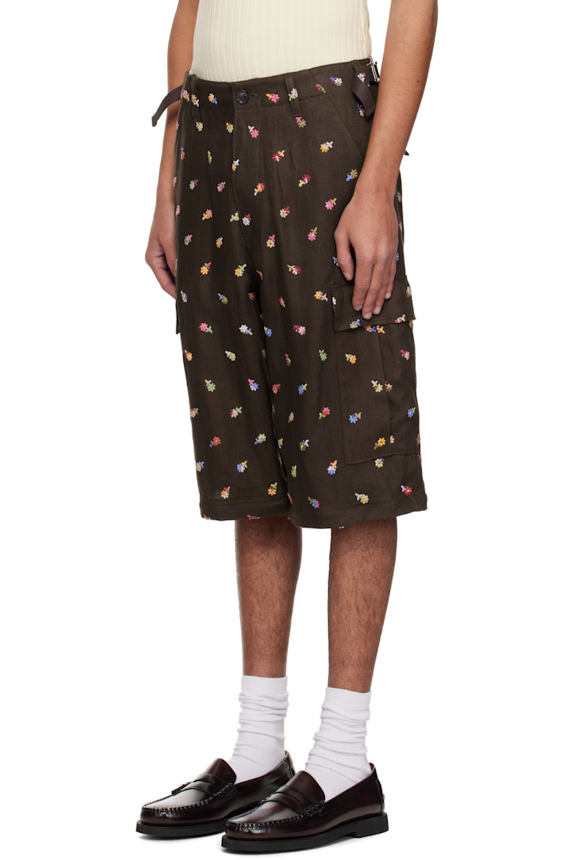 Linen twill cargo pants. Floral pattern embroidered throughout.

· Belt loops
· Four-pocket styling
· Zip fly
· Cinch straps at waistband
· Zip fastening at knees for shorts styling
· Drawstring at cuffs
· Cargo pocket at outseams
· Logo embroidered at back
· Buffalo horn hardware

Supplier color: Brown