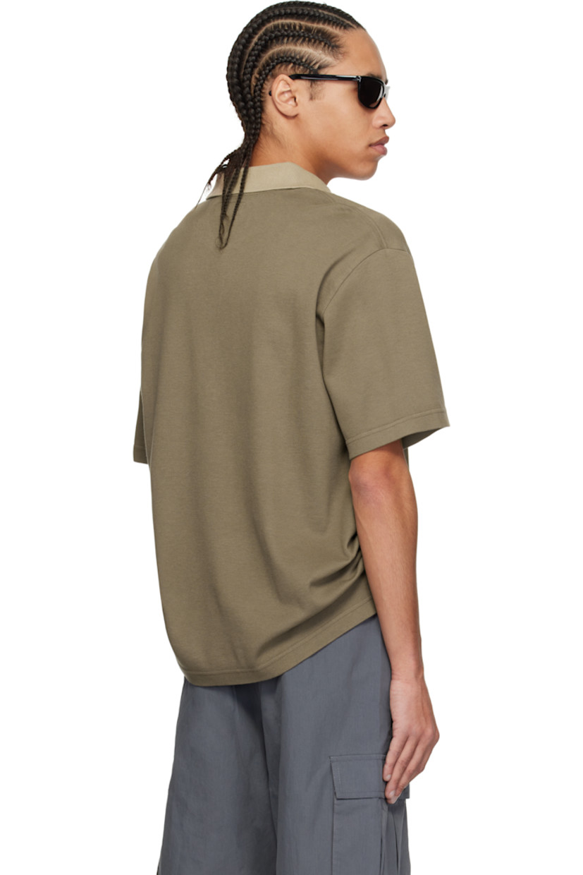 Cotton piqué polo.

· Rib-knit spread collar
· Half-zip closure
· Logo embroidered at chest
· Tennis-tail hem
· Logo flag at side seam
· Dropped shoulders

Supplier color: Stone brown/Beige