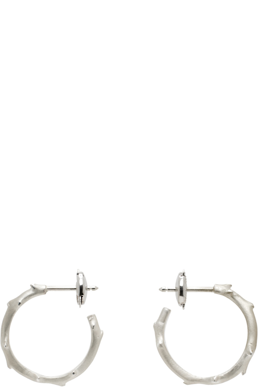 Pair of open hoop earrings in 14k white gold.

· Textured detailing throughout
· Sterling silver post-stud fastening
· D1"

Part of the FLORA collection.

Supplier color: White gold
