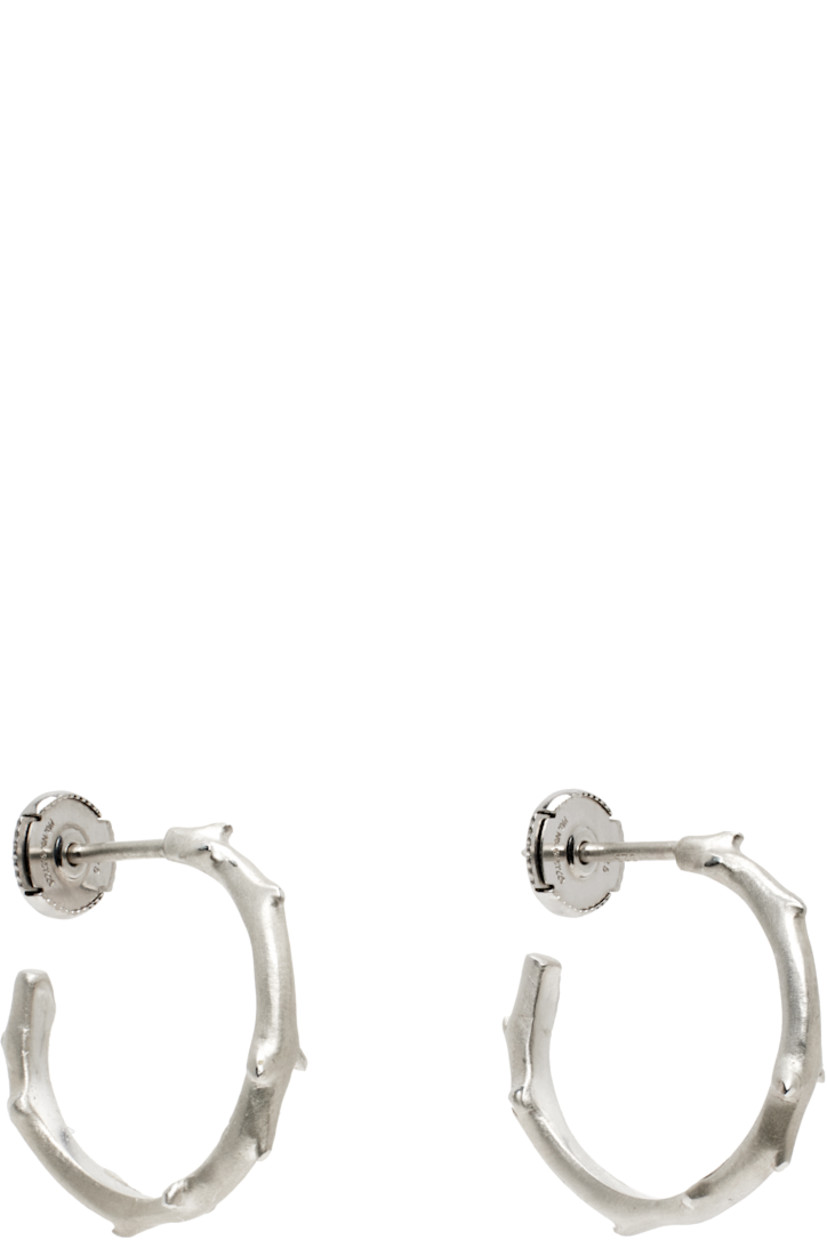 Pair of open hoop earrings in 14k white gold.

· Textured detailing throughout
· Sterling silver post-stud fastening
· D1"

Part of the FLORA collection.

Supplier color: White gold