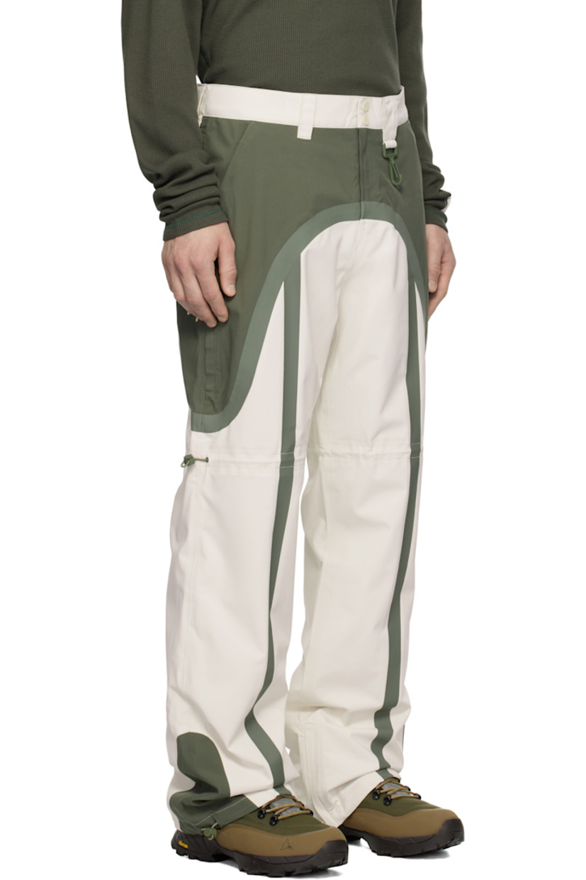 Waterproof 185 gsm recycled polyester taffeta track pants. Taped seams throughout.

· Paneled construction
· Belt loops and concealed velcro tabs at waistband
· Lanyard clasp at front waist
· Four-pocket styling
· Zip-fly
· Bungee-style drawstring at legs and cuffs
· Zip gusset at cuffs
· Full nylon jersey lining

Supplier color: Green/White