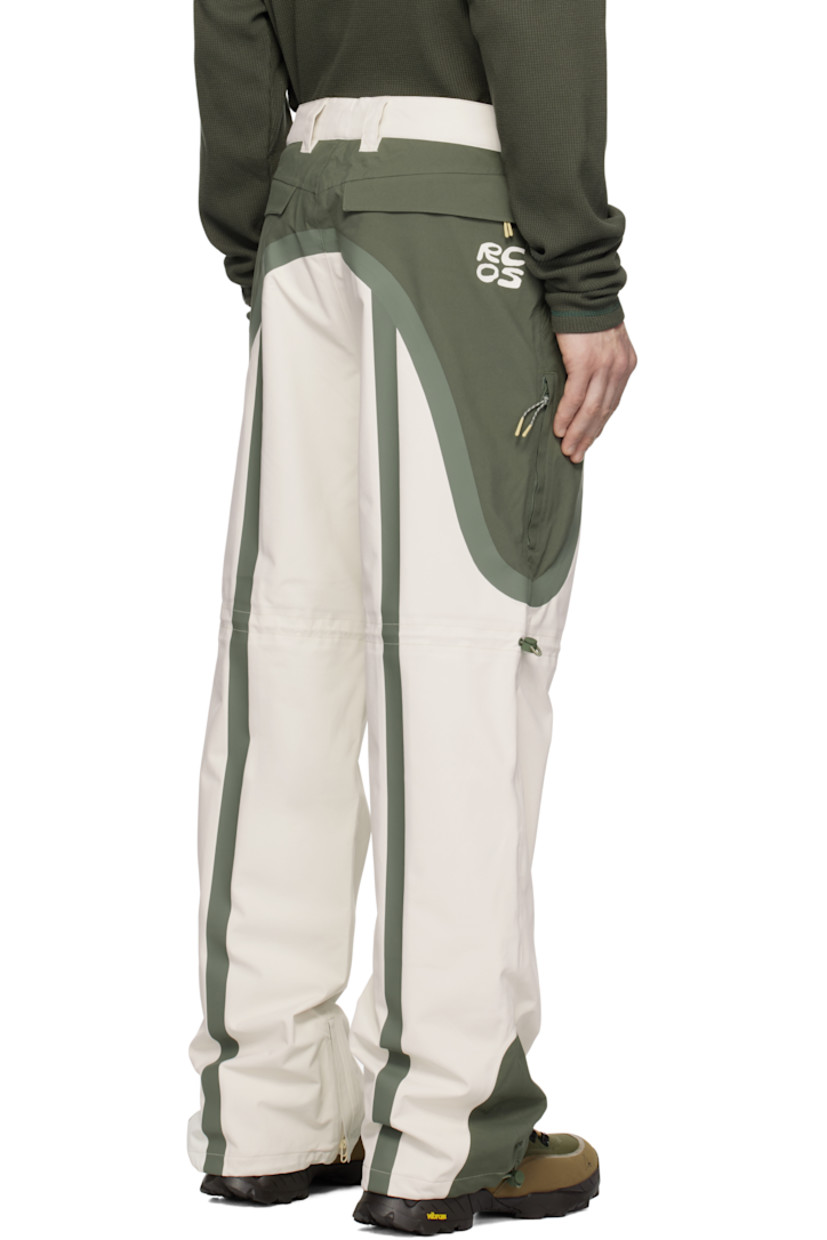 Waterproof 185 gsm recycled polyester taffeta track pants. Taped seams throughout.

· Paneled construction
· Belt loops and concealed velcro tabs at waistband
· Lanyard clasp at front waist
· Four-pocket styling
· Zip-fly
· Bungee-style drawstring at legs and cuffs
· Zip gusset at cuffs
· Full nylon jersey lining

Supplier color: Green/White