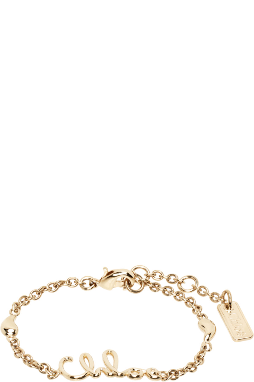Cable chain bracelet in antiqued gold-tone brass.

· Logo at face
· Charms at length
· Logo plaque at adjustable lobster-clasp fastening
· L7.5"

Supplier color: Vintage gold