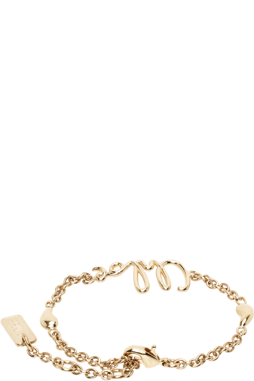 Cable chain bracelet in antiqued gold-tone brass.

· Logo at face
· Charms at length
· Logo plaque at adjustable lobster-clasp fastening
· L7.5"

Supplier color: Vintage gold