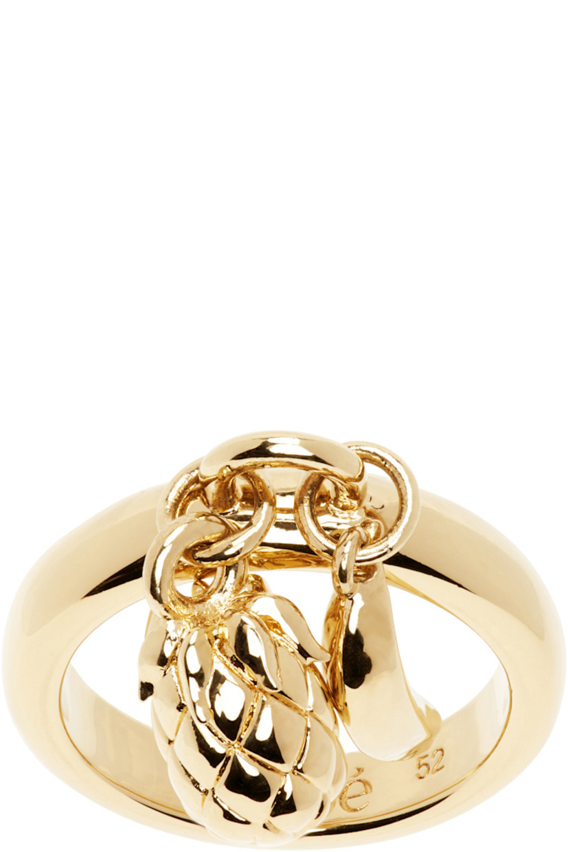 Ring in antiqued gold-tone brass. Charms at face.

Supplier color: Vintage gold