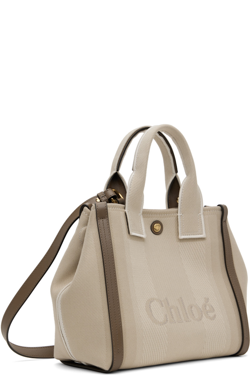 Recycled cotton-blend broken twill tote in beige. LWG-certified buffed calfskin trim throughout.

· Twin rolled carry handles
· Detachable crossbody strap
· Jacquard logo and stripes at face and back face
· Magnetic fastening at sides
· Press-stud closure
· Patch pocket at interior
· Cotton-blend twill lining
· Logo-engraved gold-tone hardware
· H9.5" x W10.5" x D4.5"

Supplier color: Vegetal beige