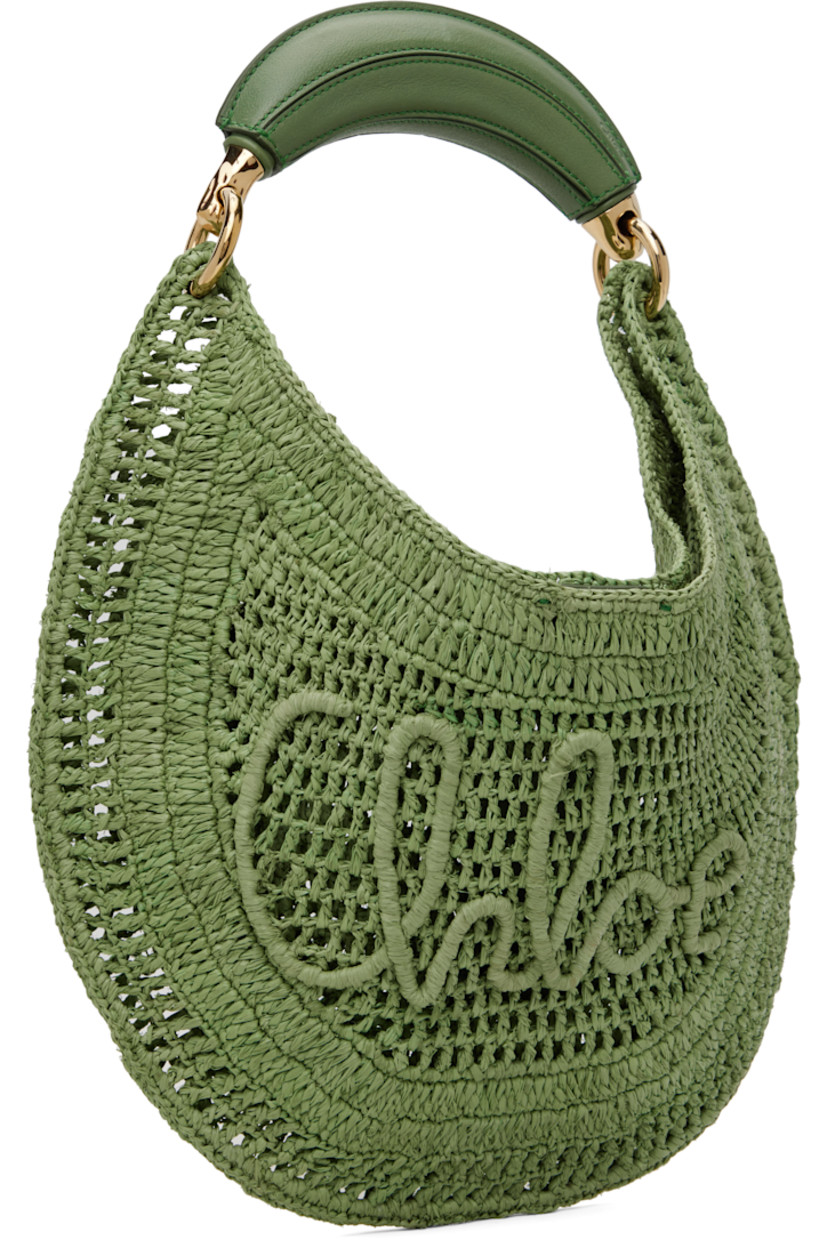 Water-repellent woven raffia top handle bag in green.

· LWG-certified buffalo leather carry handle
· Logo embossed at handle
· Woven logo appliqué at face
· Magnetic closure
· Patch pocket at interior
· Unlined
· Gold-tone hardware
· H8.75" x W14.5" x D1"

Part of the Chloé x Made For A Woman collaboration.

Supplier color: Tea leaf green