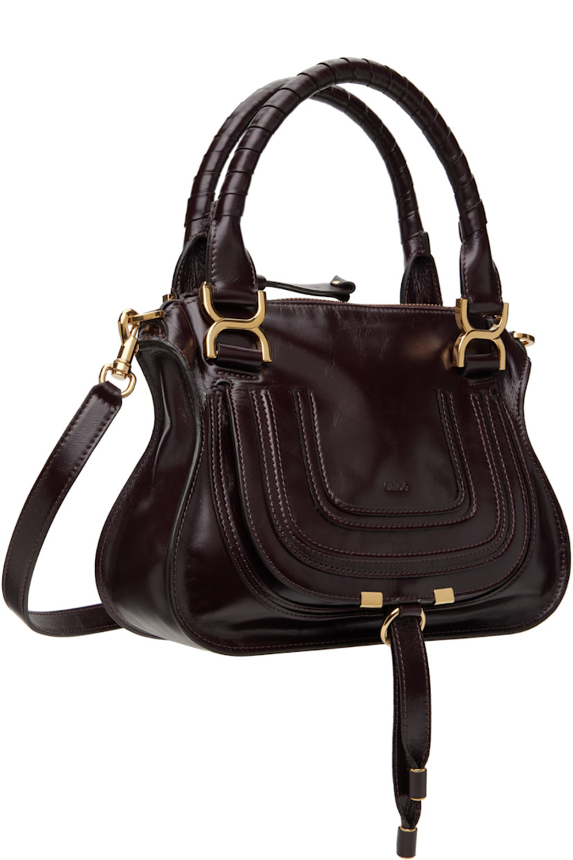 LWG-certified polished calfskin shoulder bag in burgundy.

· Hand-wrapped carry handles
· Detachable crossbody strap
· Logo embossed at face
· Tab-slot flap pocket
· Zip closure
· Zip pocket at interior
· Calfskin suede lining
· Logo-engraved gold-tone hardware
· H9" x W12" x D3.5"

Supplier color: Auburn red
