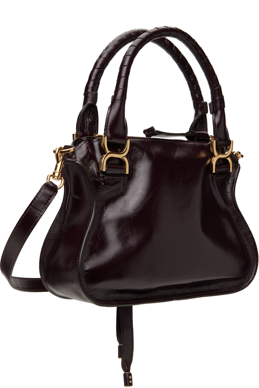LWG-certified polished calfskin shoulder bag in burgundy.

· Hand-wrapped carry handles
· Detachable crossbody strap
· Logo embossed at face
· Tab-slot flap pocket
· Zip closure
· Zip pocket at interior
· Calfskin suede lining
· Logo-engraved gold-tone hardware
· H9" x W12" x D3.5"

Supplier color: Auburn red