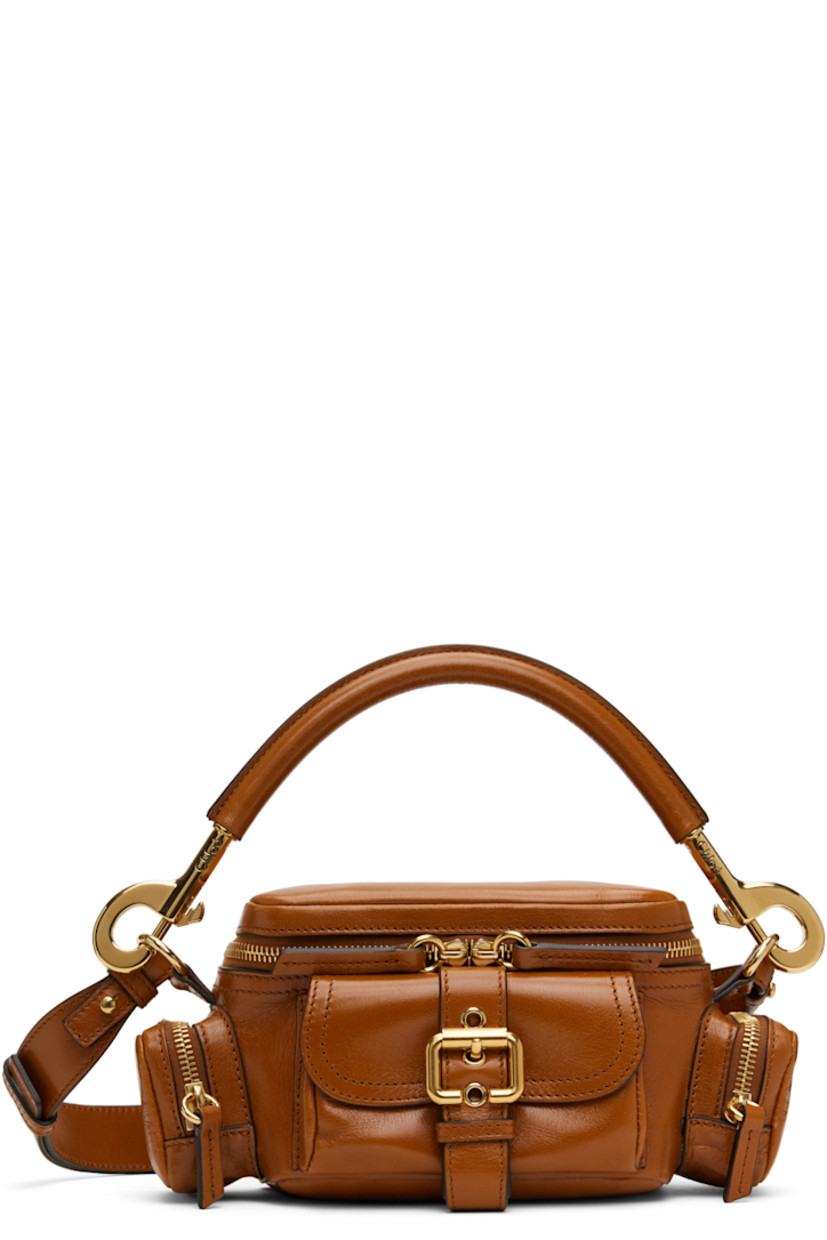 LWG-certified polished grained buffalo leather shoulder bag in tan. 

· Detachable rolled carry handle
· Detachable and adjustable crossbody strap
· Pin-buckle flap pocket at face
· Zip pocket at sides
· Two-way zip closure
· Patch pocket at interior
· Cotton- and linen-blend canvas lining
· Logo-engraved gold-tone hardware
· H5" x W7.5" x D4"

Supplier color: Clay brown