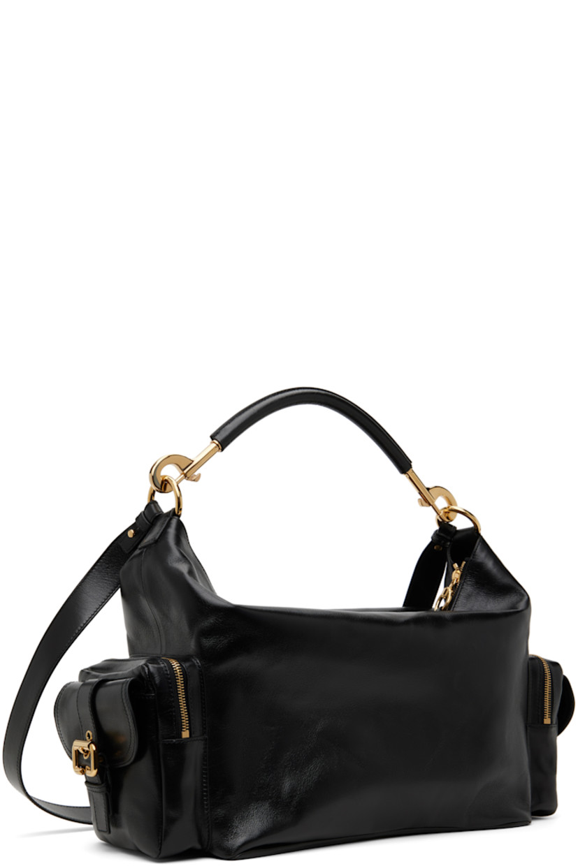 LWG-certified nappa buffalo leather shoulder bag in black.

· Detachable shoulder strap
· Detachable and adjustable post-stud crossbody strap
· Logo embossed at face
· Flap pocket at face
· Zip and flap pocket at sides
· Zip closure
· Patch pocket at interior
· Canvas lining
· Logo-engraved gold-tone hardware
· H9" x W17" x D6"

Supplier color: Black