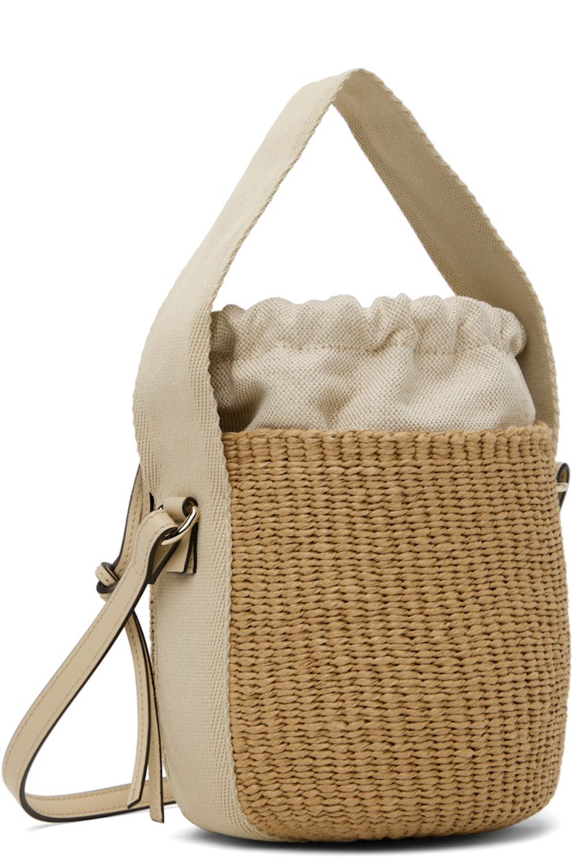 Woven raffia and buffed calfskin shoulder bag in beige.

· Fixed carry handle and shoulder strap
· Logo patch at face 
· Logo embossed at base
· Drawstring closure
· Canvas lining
· H8" x W7" x D6"

Supplier color: Deep ivory