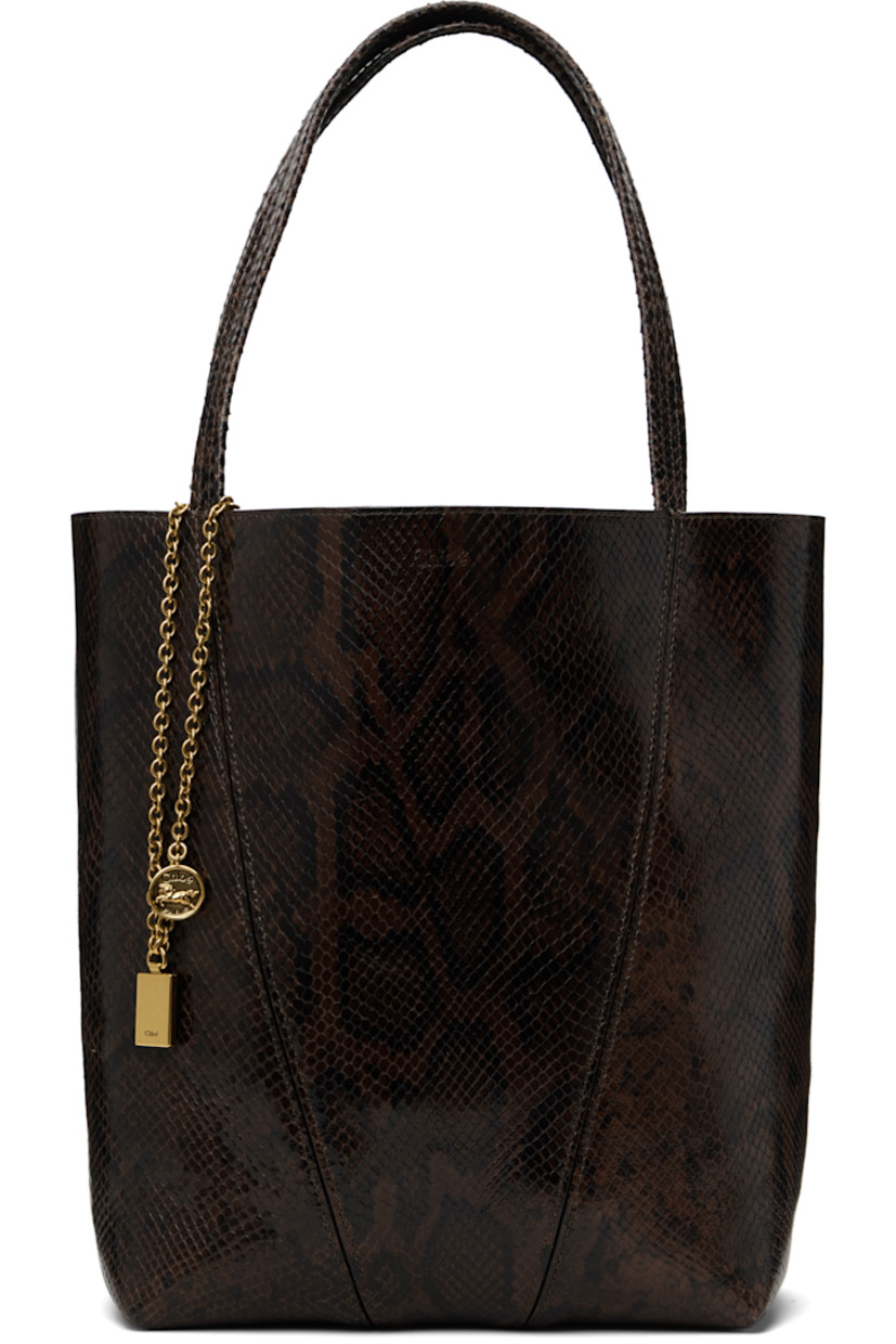 Snake-embossed goatskin tote in brown.

· Twin carry handles
· Detachable logo charms at handle 
· Logo stamp at face
· Lanyard clasp at interior
· Calfskin suede lining
· Gold-tone hardware
· H12" x W10.5" x D5.5"

Supplier color: Sooty brown