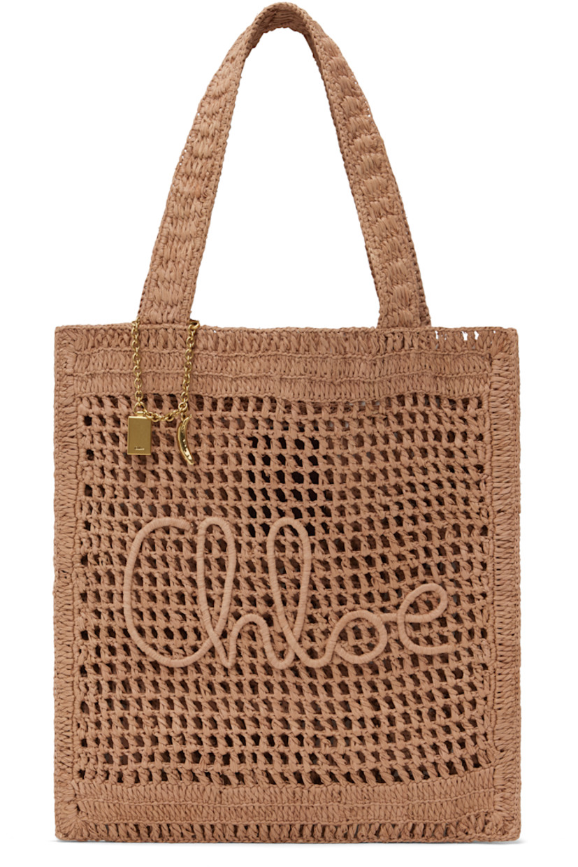 Handwoven raffia tote in beige.

· Twin shoulder straps
· Chain with logo charms at strap base
· Logo embroidered at face
· Patch pocket at interior
· Unlined
· Logo-engraved gold-tone hardware
· H14.5" x W13.25"

Part of the Chloé x Made For A Woman collaboration.

Supplier color: Summery beige