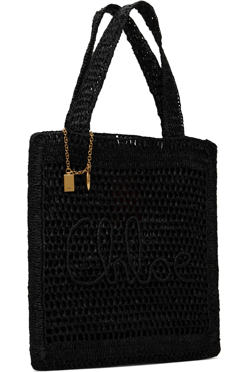 Woven raffia tote in black.

· Twin shoulder straps
· Chain with logo charms at strap base
· Logo embroidered at face
· Open throat
· Patch pocket at interior
· Unlined
· Logo-engraved gold-tone hardware
· H14.5" x W13.5"

Supplier color: Black