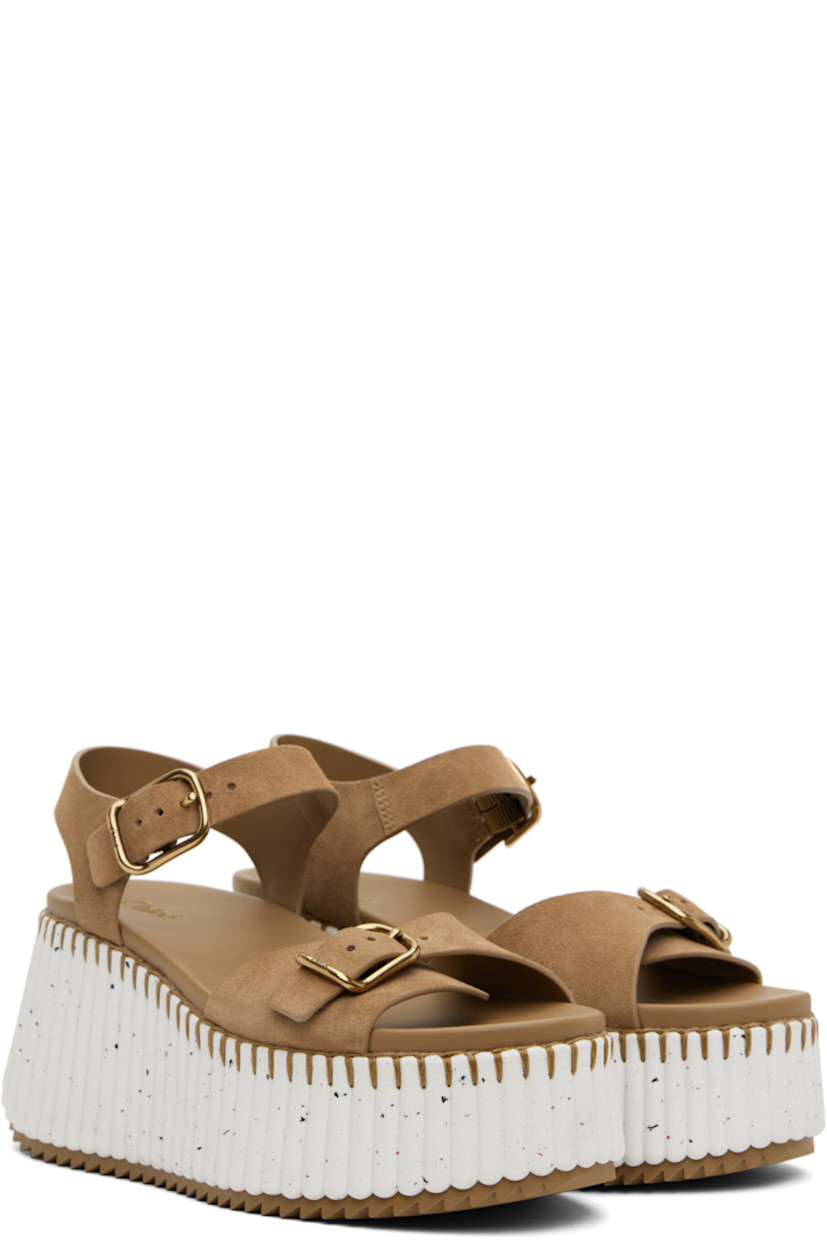 Suede sandals in brown.

· Open toe
· Pin-buckle strap at vamp
· Pin-buckle slingback strap
· Logo-embossed buffed leather footbed
· Textured platform midsole
· Treaded rubber sole
· Platform: H2.25"
· Heel: H3.5"

Supplier color: Dune brown