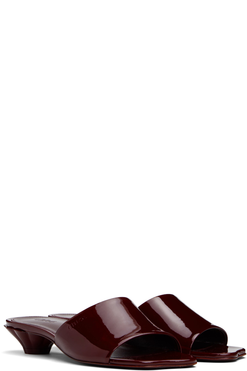 Patent calfskin slip-on flat sandals in burgundy.

· LWG-certified
· Open square toe
· Logo embossed at vamp
· Logo embossed at goatskin footbed
· Sculptural kitten heel with rubber injection
· Polished leather sole
· Heel: H1.5"

Supplier color: Obscure red