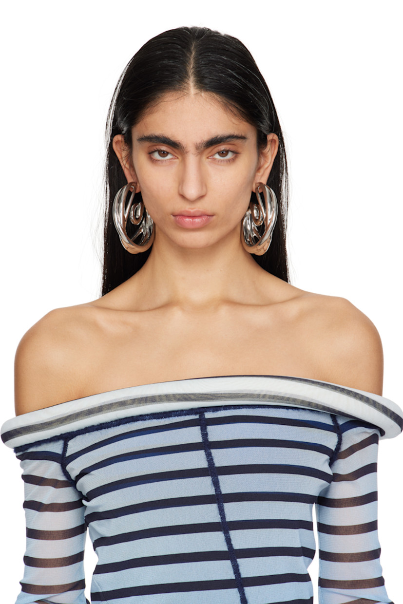 Pair of open hoop earrings in rhodium-plated copper. Twisted detailing throughout.

· Post-stud fastening 
· D3"

Supplier color: Copper/Silver