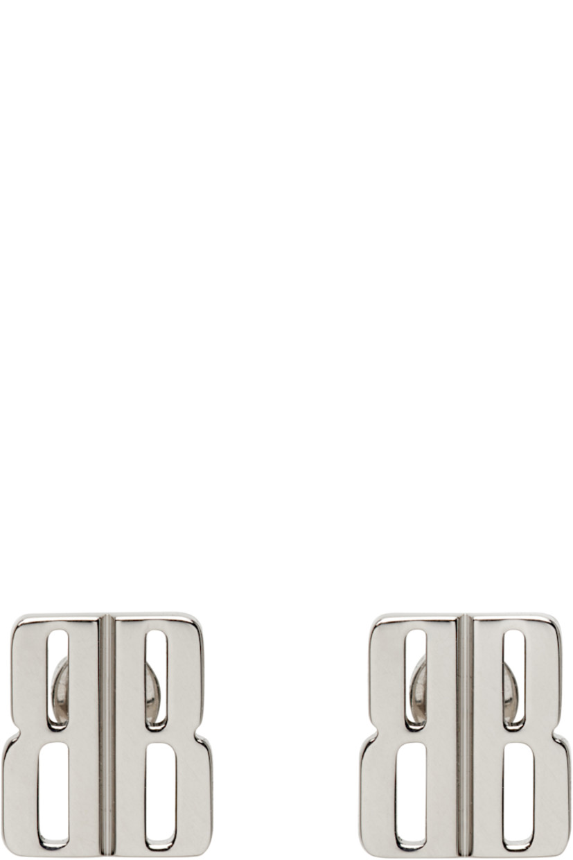 Pair of stud earrings in silver-tone brass. 

· Logo cutout at face
· Post-stud fastening 
· H0.5" x W0.5" 

Supplier color: Silver