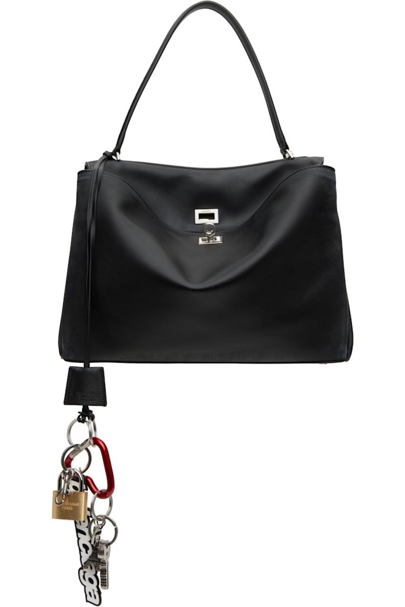 Smooth calfskin duffle bag in black. Detachable sheathed keyring, logo-engraved key charms, logo graphic charms, and logo-engraved graphic lanyard clasp at strap.

· Fading and distressing throughout
· Fixed shoulder strap
· Detachable crossbody strap
· Press-stud fastenings at sides
· Patch pockets at back face
· Bumper studs at base
· Turn-lock closure
· Zip pocket at two-compartment interior
· Nappa lambskin lining
· Logo-engraved antiqued silver-tone hardware
· H9.5" x W13.5" x D4.25"

Supplier color: Black