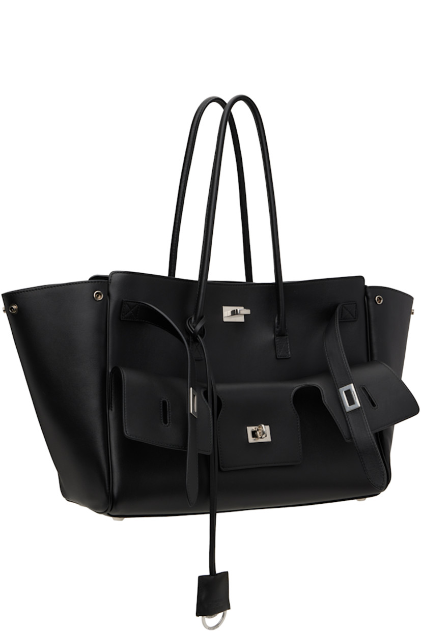 Buffed calfskin top handle bag in black.

· Rolled shoulder straps
· Detachable sheathed keyrings at strap base
· Fold-down pocket with turn-lock straps at face
· Press-stud fastenings at sides
· Silver-tone logo stamp at back face
· Bumper studs at base
· Open throat
· Zip and patch pockets at interior
· Bonded nappa lambskin lining
· Logo-engraved antiqued silver-tone hardware
· H11" x W14.5" x D6.75"

Supplier color: Black