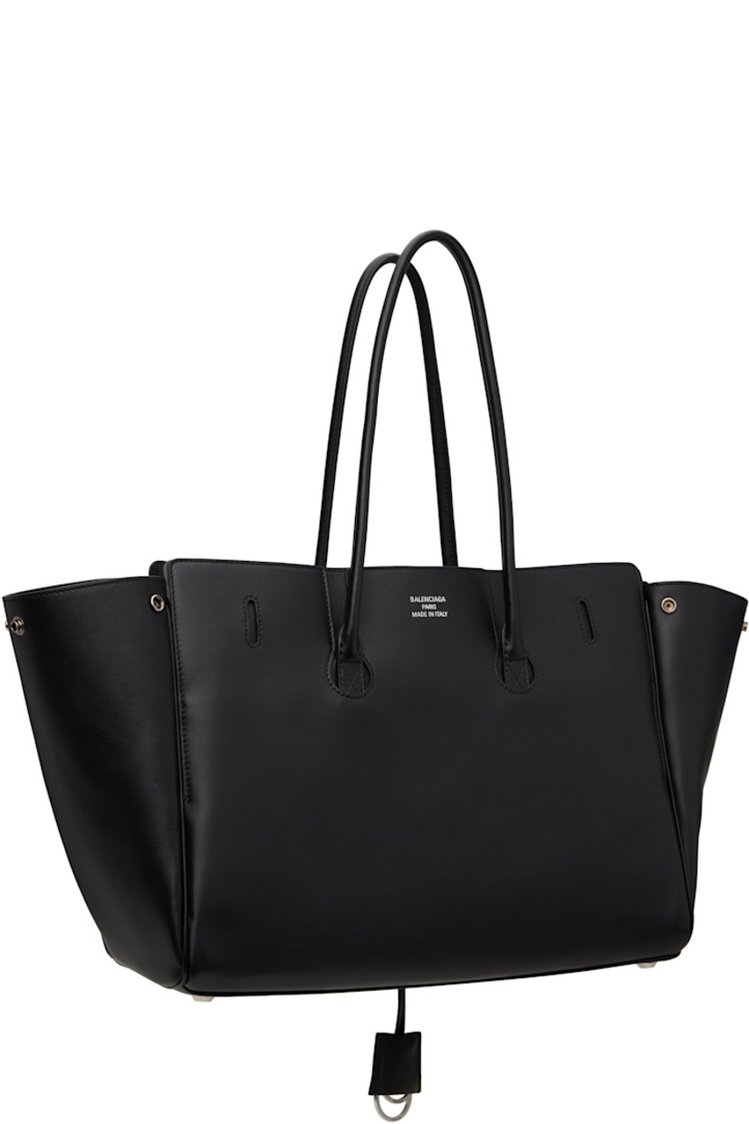 Buffed calfskin top handle bag in black.

· Rolled shoulder straps
· Detachable sheathed keyrings at strap base
· Fold-down pocket with turn-lock straps at face
· Press-stud fastenings at sides
· Silver-tone logo stamp at back face
· Bumper studs at base
· Open throat
· Zip and patch pockets at interior
· Bonded nappa lambskin lining
· Logo-engraved antiqued silver-tone hardware
· H11" x W14.5" x D6.75"

Supplier color: Black