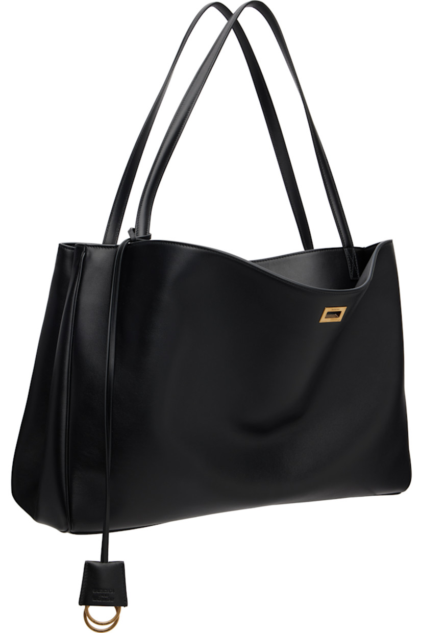 Grained calfskin tote.

· Twin fixed shoulder straps
· Detachable logo-embossed sheathed keyrings
· Patch pocket at face
· Press-stud accordion panel at sides
· Patch pockets at back face
· Bumper studs at base
· Turn-lock closure
· Zip pocket at interior 
· Nappa lambskin lining
· Logo-engraved antiqued gold-tone hardware
· H11.5" x W17.5" x D6.5"

Supplier color: Black