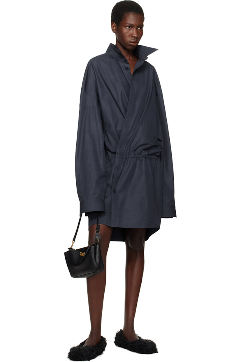 Buffed calfskin shoulder bag in black.

· Detachable shoulder strap
· Detachable sheathed keyrings at strap
· Turn-lock compartment at face
· Zip closure
· Three card slots
· Grained lambskin lining
· H5.5" x W8.5" x D2.5"

Supplier color: Black