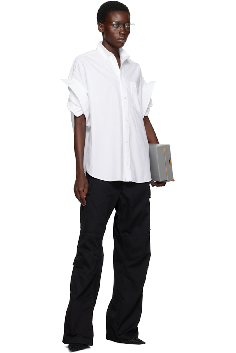 Polyester- and cotton-blend twill cargo pants. 

· Mid-rise 
· Belt loops
· Cinch tabs at waistband
· Four-pocket styling
· Zip fly
· Darts at knees
· Cargo pockets at outseams

Supplier color: Black