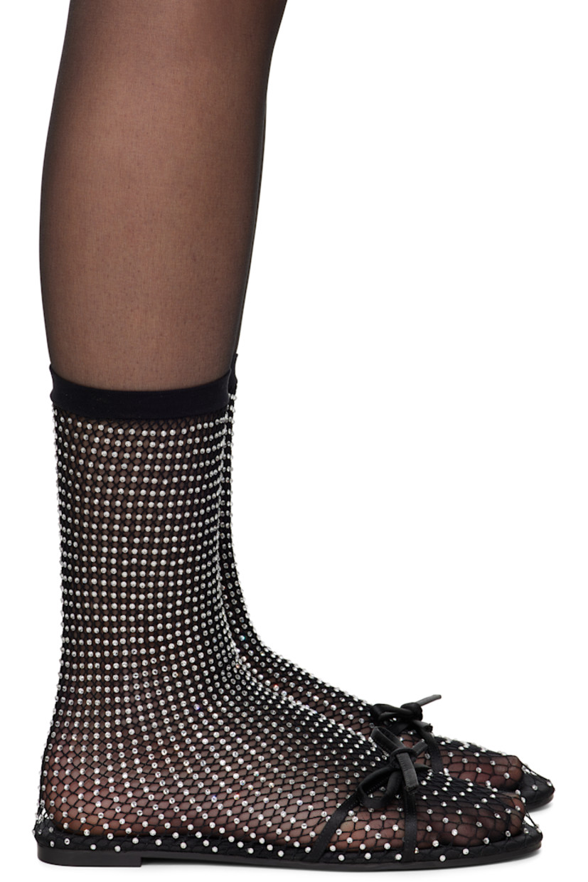 Semi-sheer mesh ballerina flats in black. Crystal-cut accents throughout.

· Bow accent at vamp
· Elasticized sock-style collar
· Unlined
· Rubber sole

Supplier color: Black