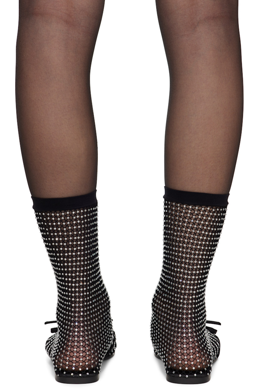 Semi-sheer mesh ballerina flats in black. Crystal-cut accents throughout.

· Bow accent at vamp
· Elasticized sock-style collar
· Unlined
· Rubber sole

Supplier color: Black