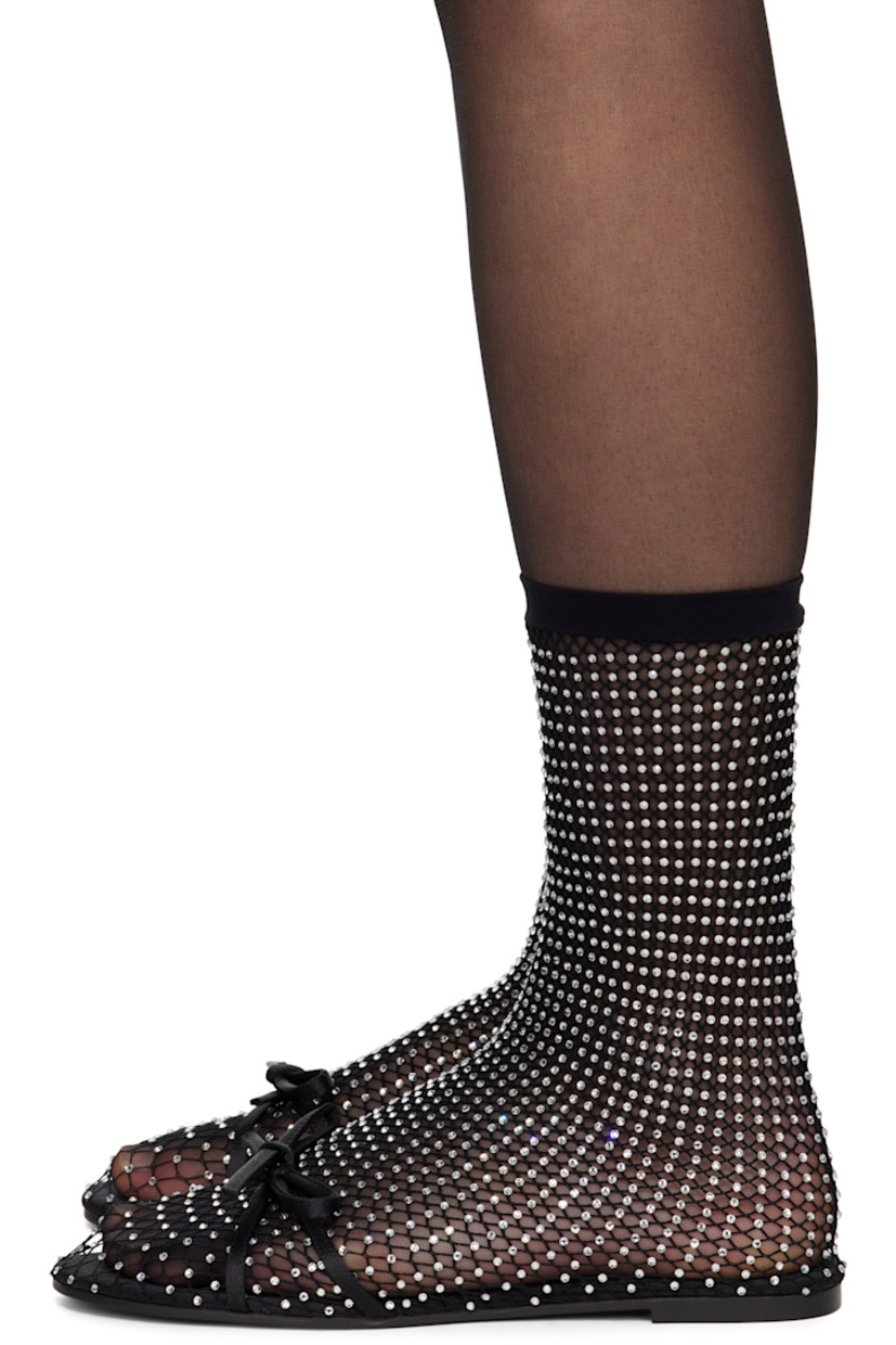 Semi-sheer mesh ballerina flats in black. Crystal-cut accents throughout.

· Bow accent at vamp
· Elasticized sock-style collar
· Unlined
· Rubber sole

Supplier color: Black